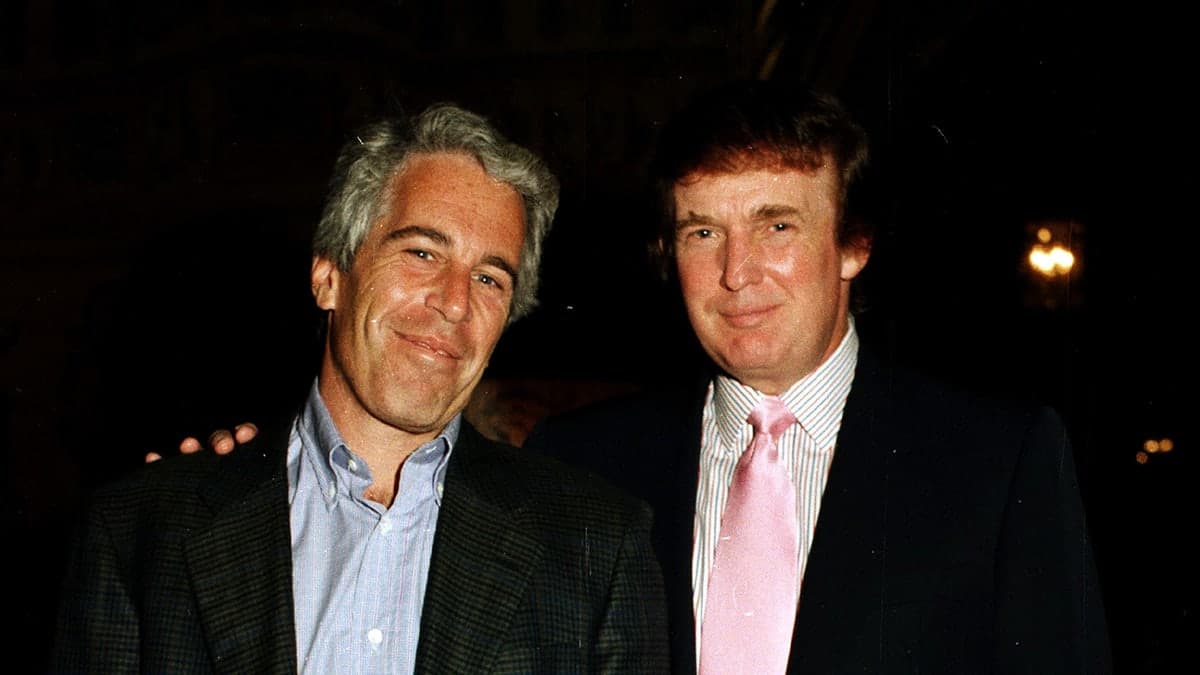 The DOJ released a photo of Epstein holding a 'novelty check' signed with Donald Trump's name, framed with 'Once in a Blue Moon' around the edge — documented evidence
